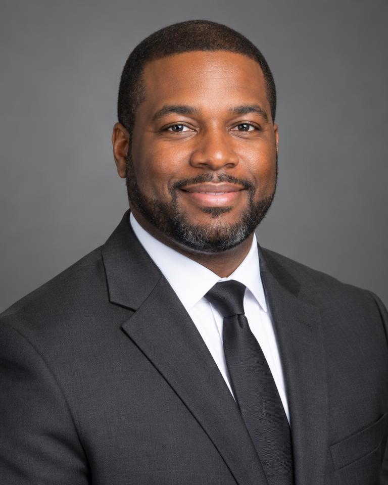 Portrait of Marcus Bennett, litigation partner, in a charcoal suit