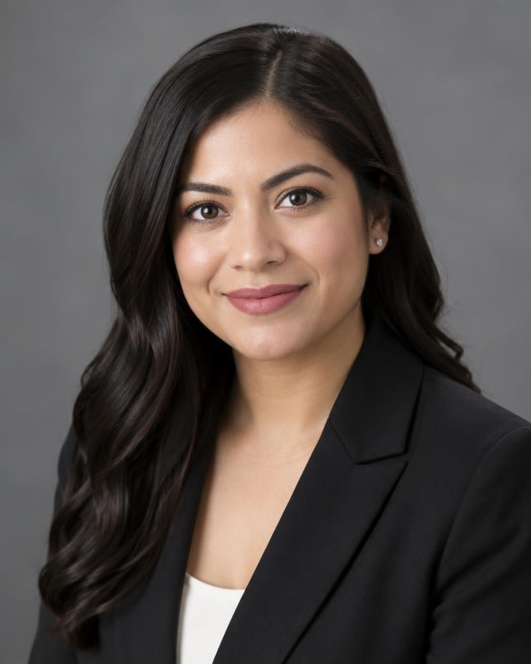 Portrait of Sofia Ramirez, associate attorney, in a dark blazer
